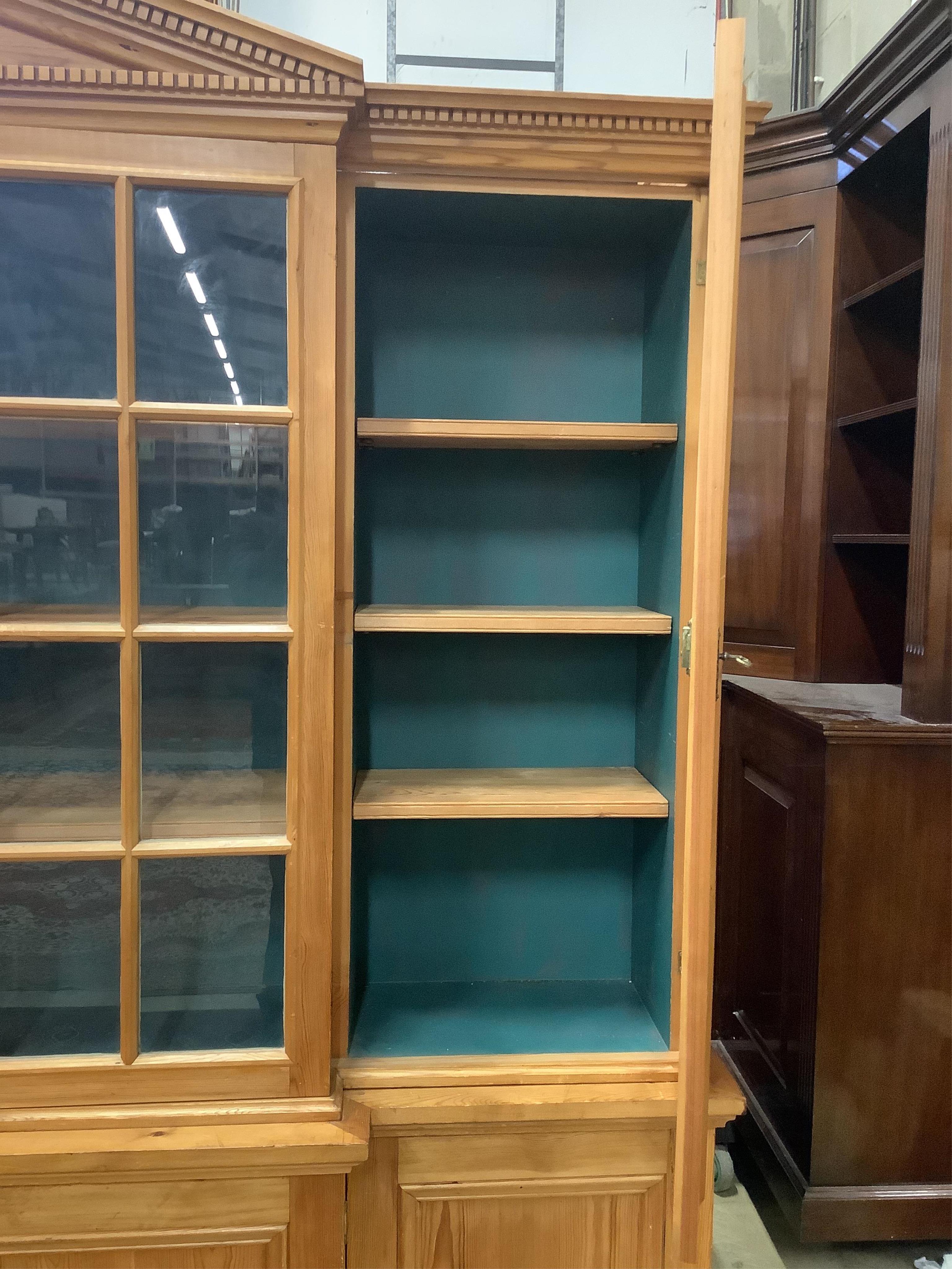 A modern pine breakfront bookcase, width 194cm, depth 44cm, height 207cm. Condition - fair to good